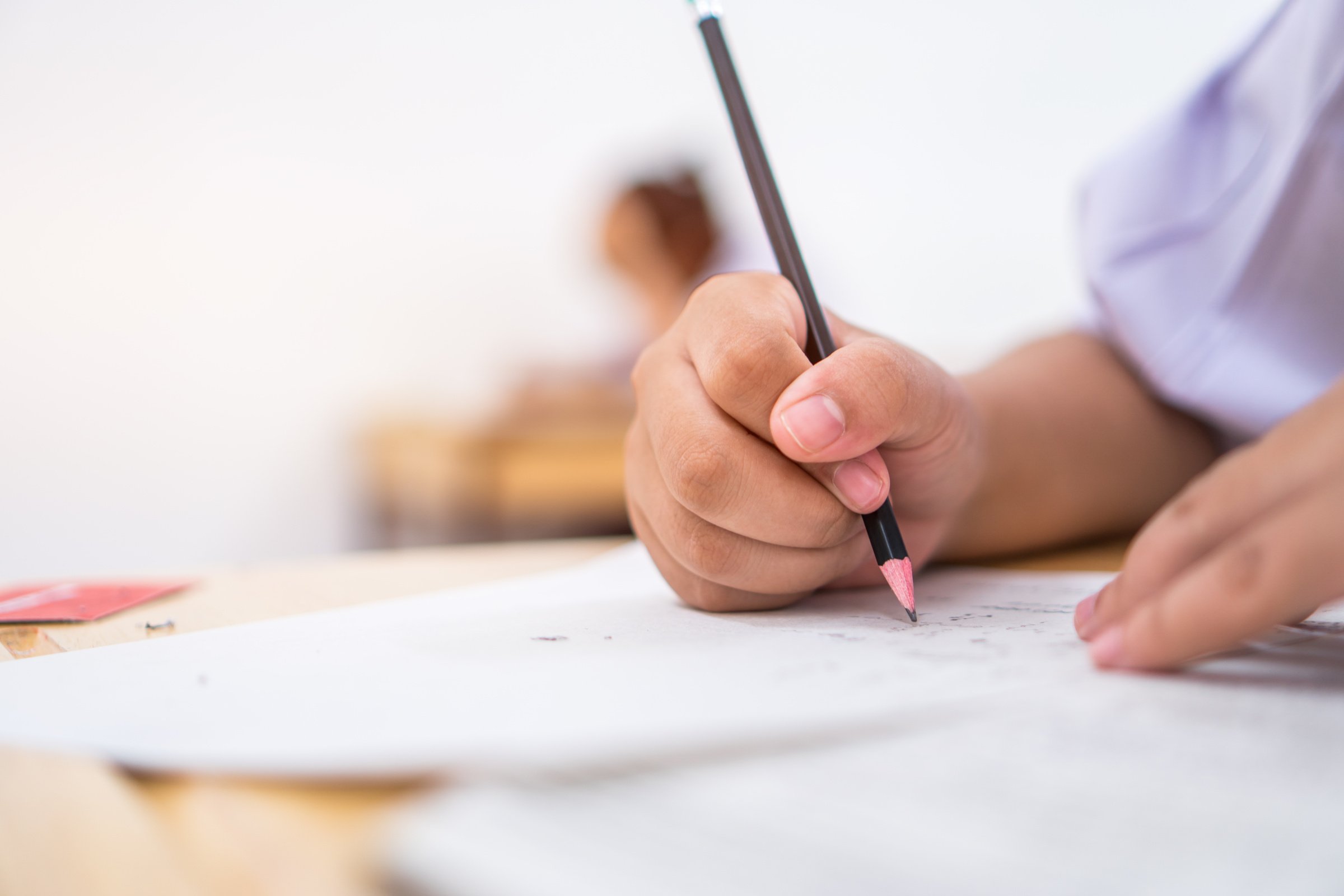 Education students testing exam with pencil drawing selected multiple-choice quizzes or testing exams answer sheets exercises in school, college university classroom